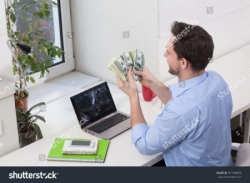 2020/04/ad-stock-photo-male-freelancer-counting-money-or-dollars-in-office-while-working-on-laptop-or-computer-handsome-391304305-jpg-br48.jpg
